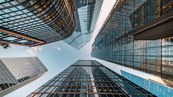upward view of glass tall corporate buildings
